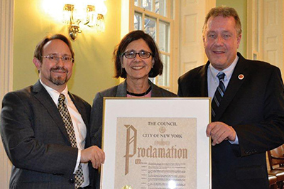 Professors Stacy Caplow and Dan Smulian, left, with NYC Councilmember Daniel Dromm