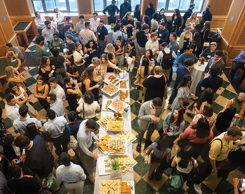 Large crowd of people around a snack table
